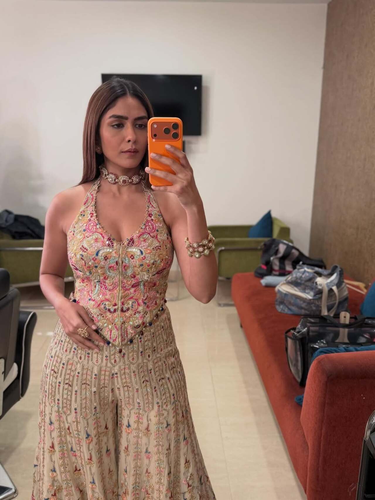 Mrunal stuns in this embellished ivory georgette embroidered high waist sharara set. She pairs it with a statement choker, matching bangles, and sleek straight hair.