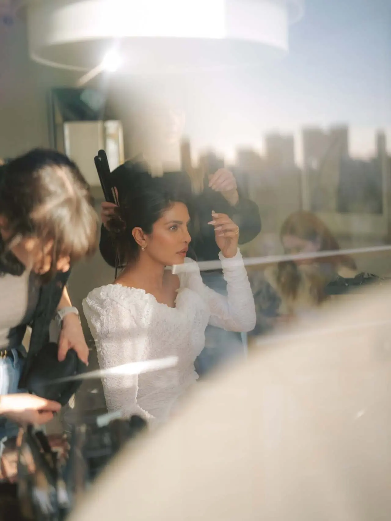 A behind-the-scenes glimpse shows Priyanka Chopra getting glammed up by before stepping out. The candid moment highlights the magic that goes into creating her stunning press appearances.