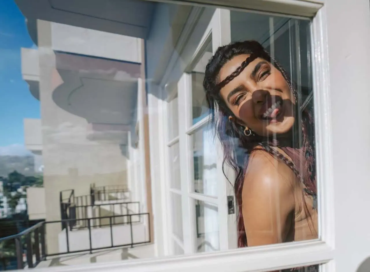 In one of the moments, PeeCee playfully strikes a goofy, charming pose while peeping out from a window, showing her fun and candid side. 