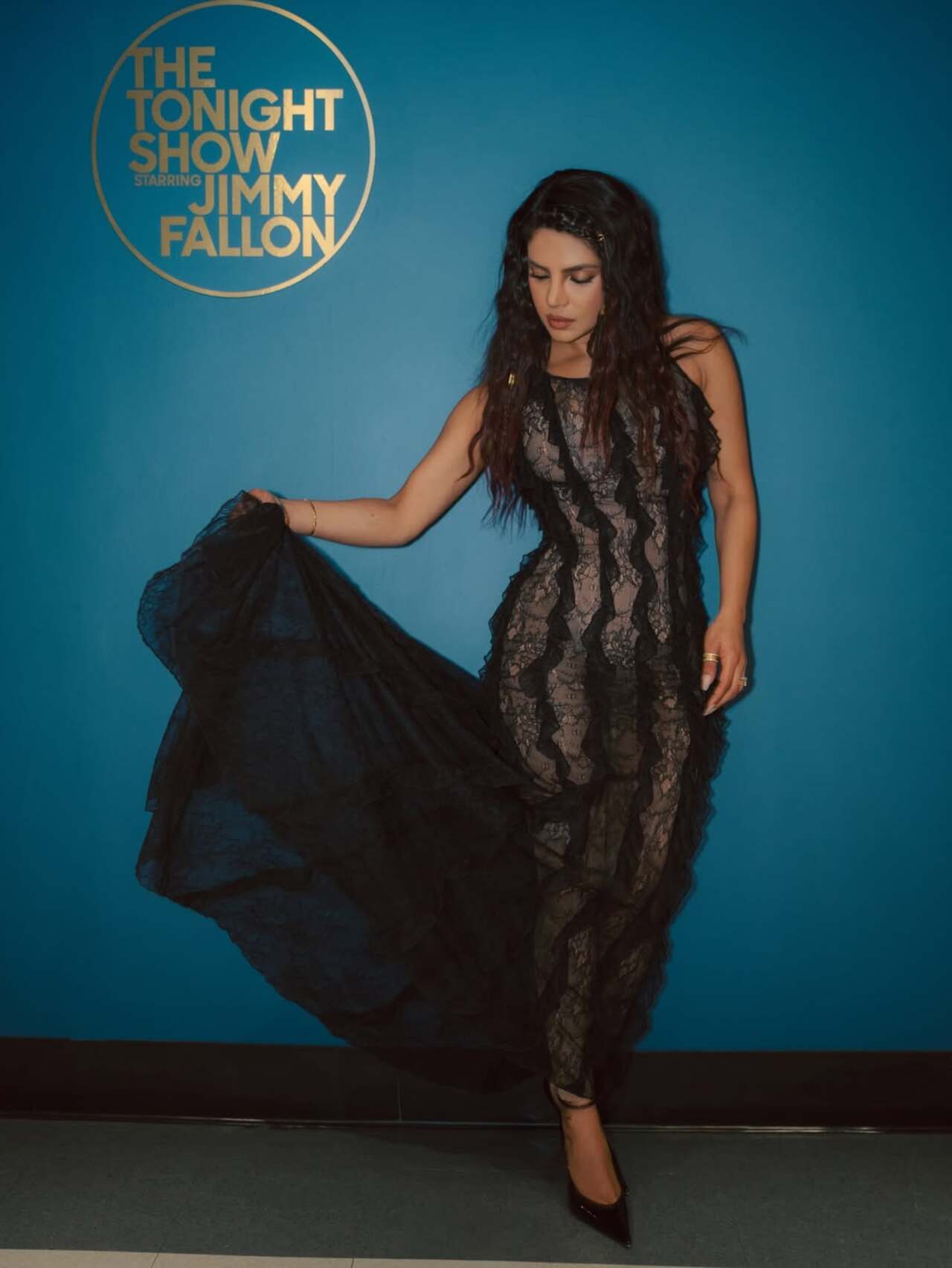 The actress slipped into a sheer lace look while promoting the movie at The Tonight Show Starring Jimmy Fallon. The star wore a completely see-through Epuzer black lace tank dress with vertical ruffles down the front.