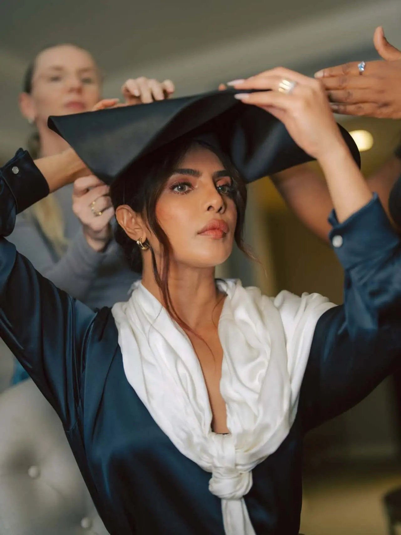 







The bold hat and flowing white scarf detail add drama and movement, making the promotional look stylish and eye catching.







