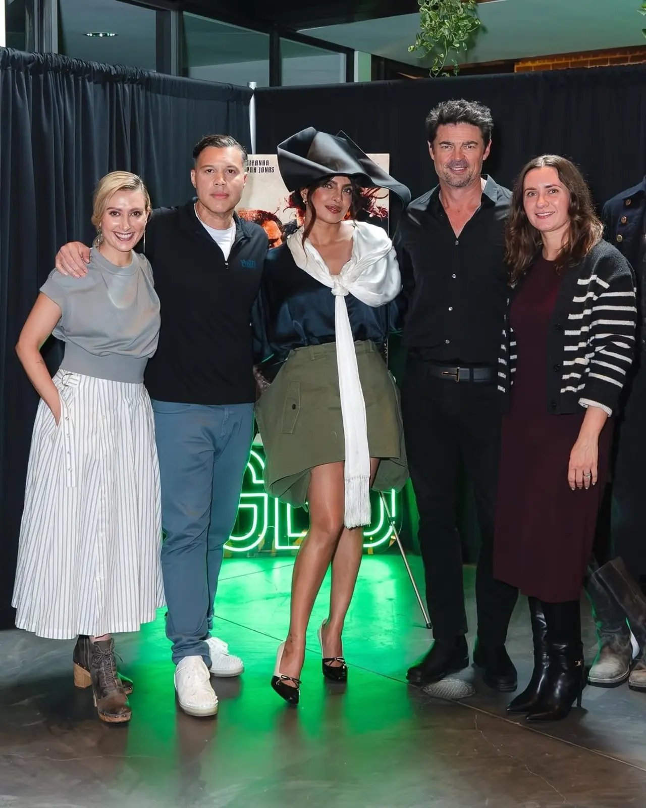 Priyanka Chopra Jonas poses happily with the cast and crew of The Bluff, celebrating the team spirit behind the project. The group picture captures the joyful promotional mood.