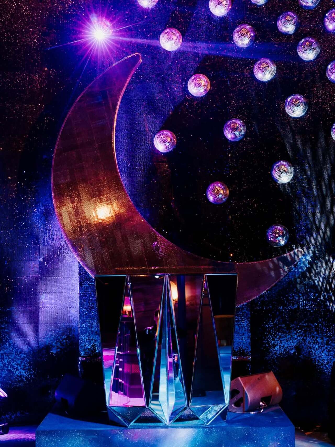 The lavish affair was decked out in shimmering disco balls that reflected light across the room, creating a glamorous party vibe.