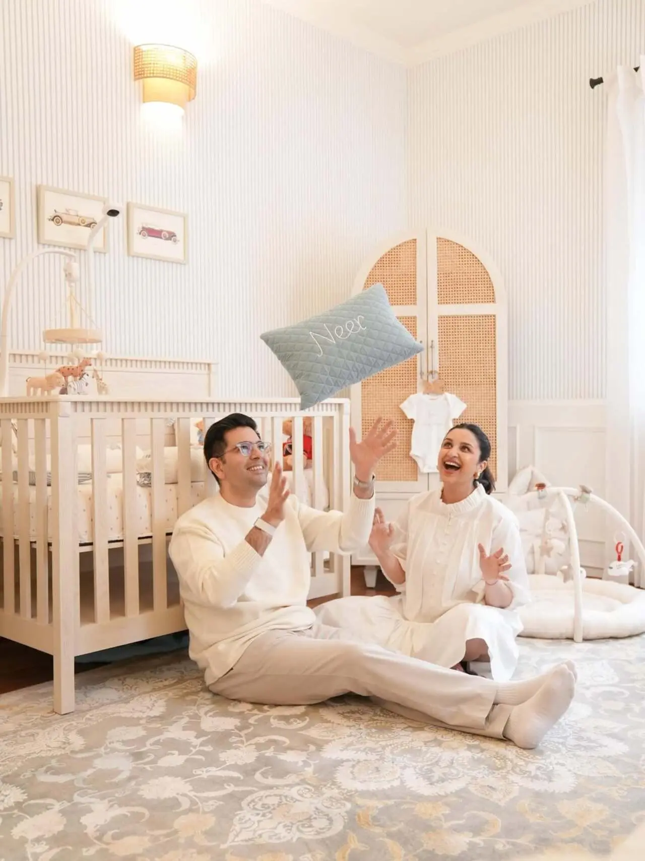This picture reflects Parineeti and Raghav's joy as they enjoy the space and it's cosy vibes. The parents are seen holding Neer's customised pillow.
