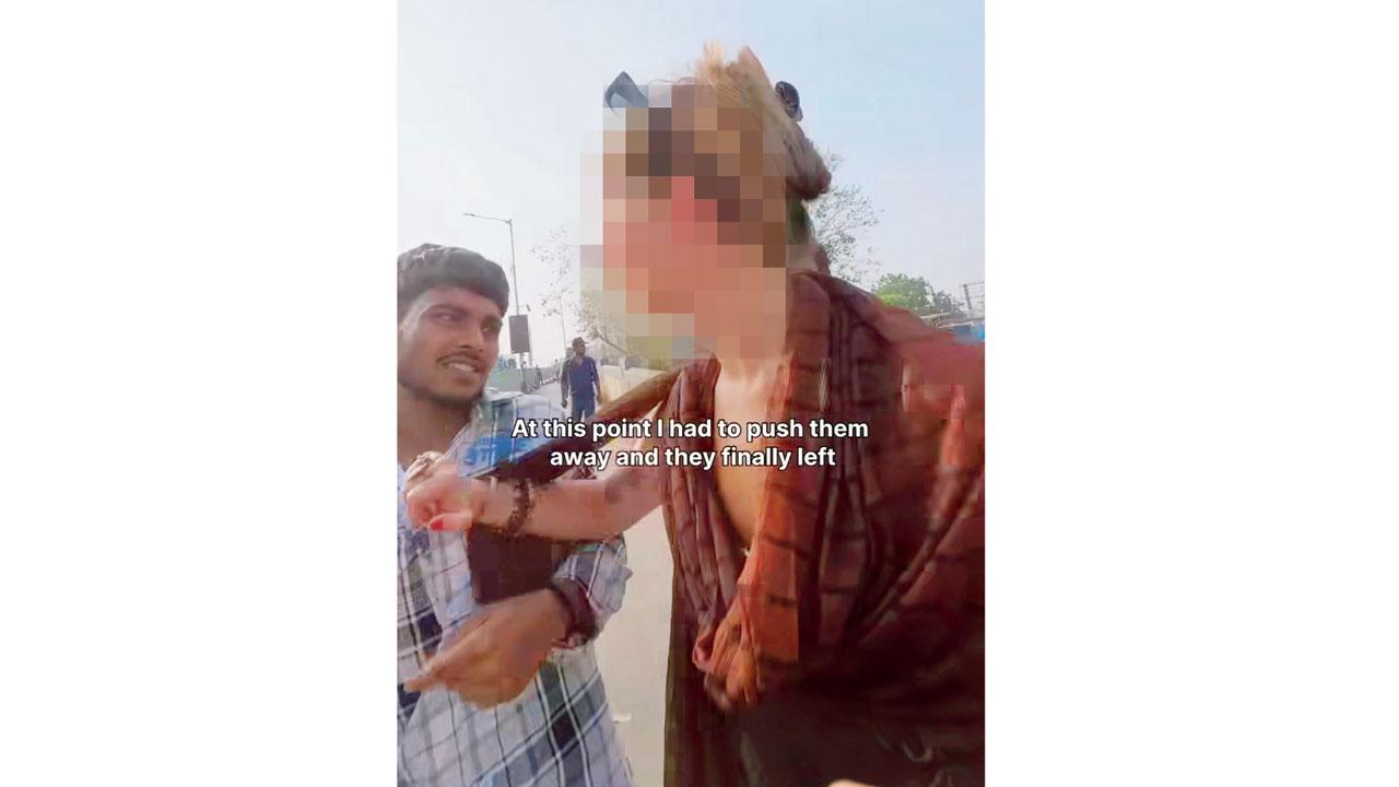 At the end of the clip, the traveller is seen pushing one of the men away