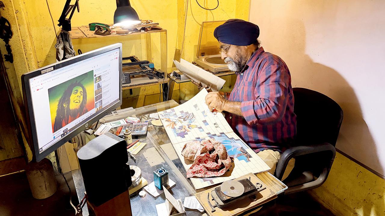 Singh browses through vinyl records on his workdesk 