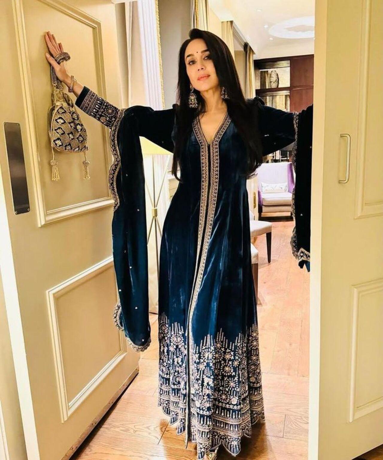 Preity Zinta's blue velvet anarkali suit screams royalty with its antique gold aari and zardosi work. 