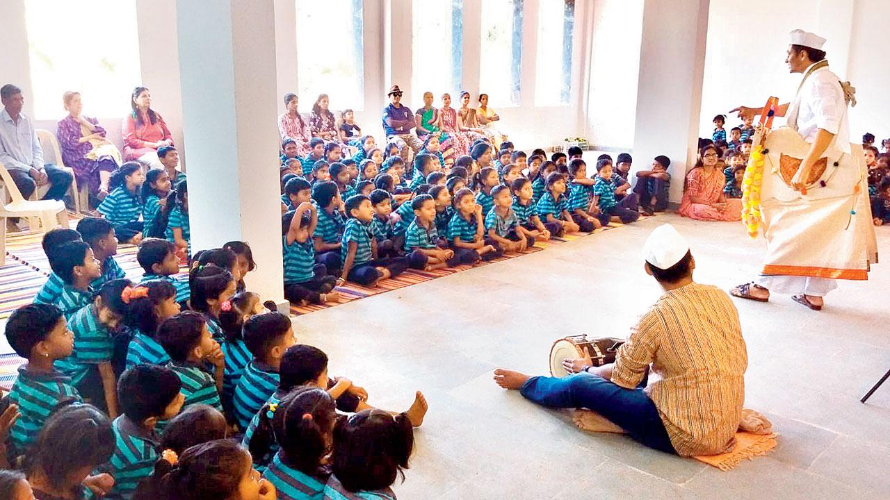 Children at Kamal Vidyalaya watch performers enact a scene from the play. Pics Courtesy/Gillo Repertory Theatre
