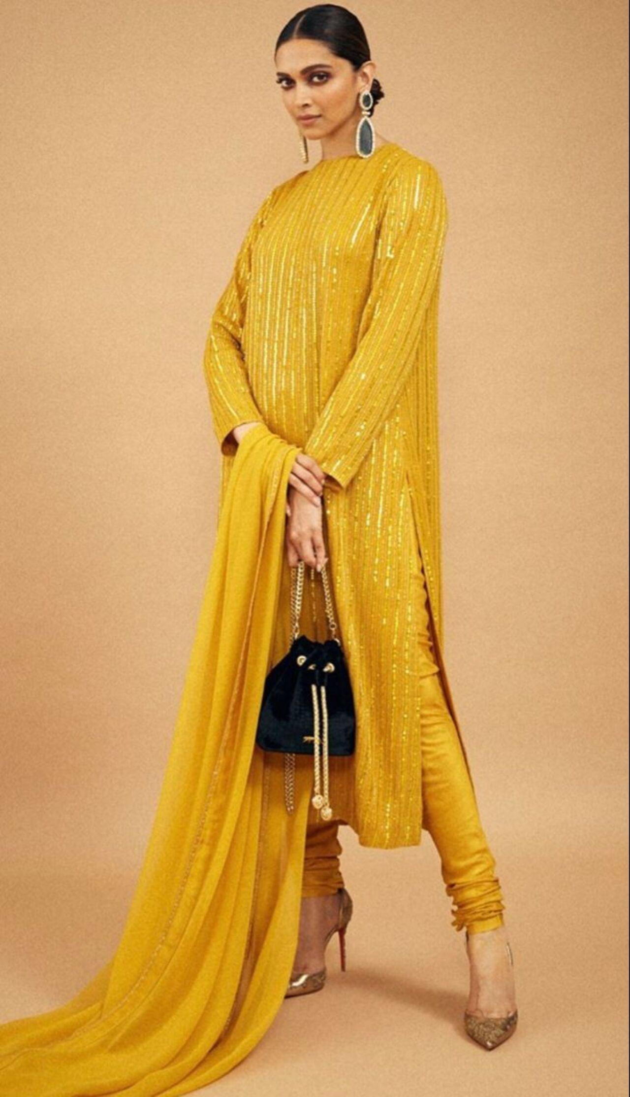 Keeping it simple, effortless yet vibrant and chic, Deepika Padukone adorns this regal mustard yellow velvet kurta with all-over sequin work, paired with a chudidaar and high heels.