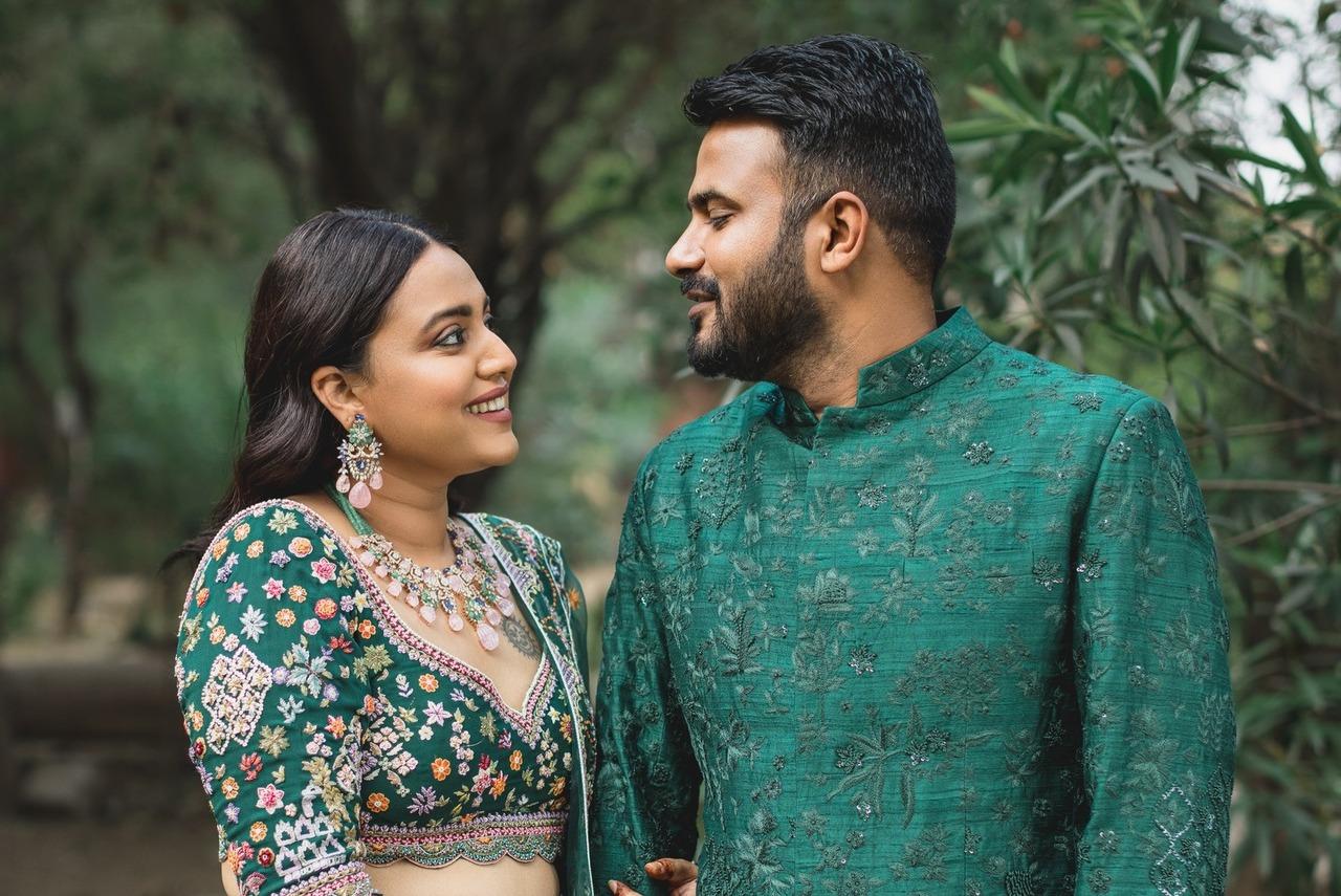 The couple seems to be lost in each other's eyes as they twin in matching green outfits.