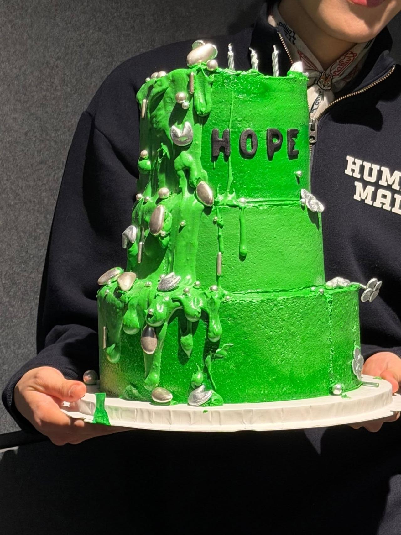 One of his cakes was a huge three-tier green cake which featured a dripping design with silver fortune cookies and other sprinklers and the word hope written on it.