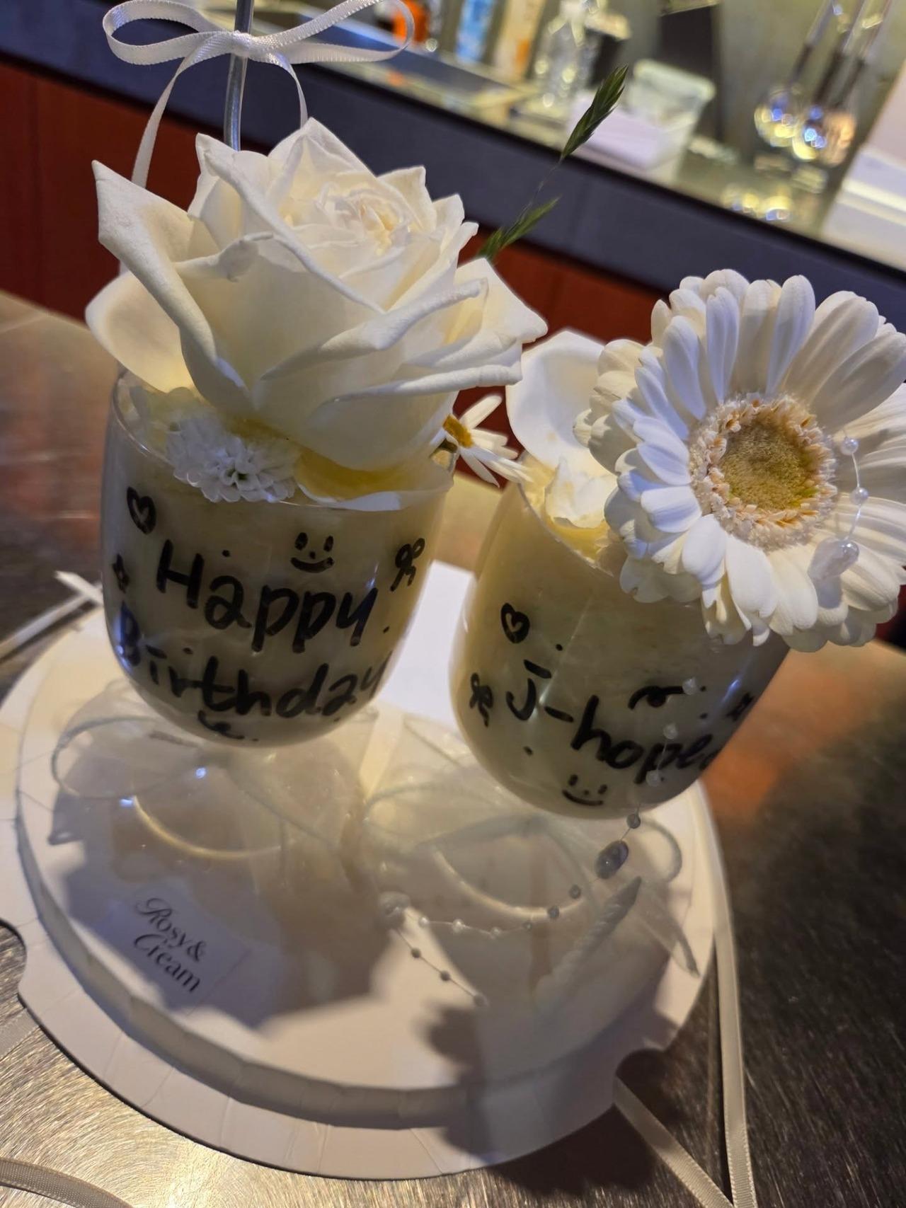 He was also seemingly greeted with two glasses of dessert decorated with white flowers. The glasses had 'Happy Birthday J-hope' written on them.