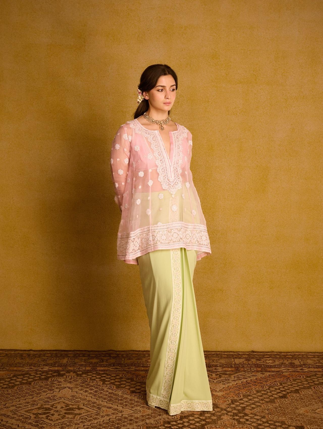 Alia Bhatt slays in this pastel-hued sheer organza kurta paired with a contrasting sarong, giving laid-back yet stylish vibes. Pair it with flowers in the head to make it poetic and memorable.
