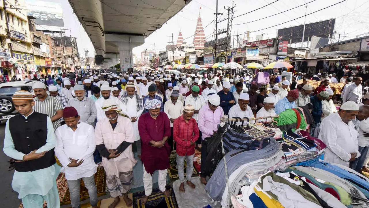 Worshippers offer prayers below a bridge in Patna