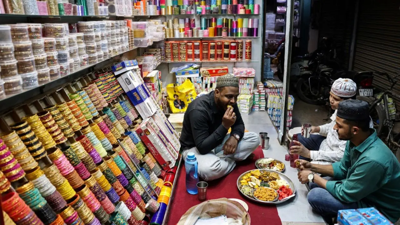 Shopkeepers pause to break their fast during Ramadan in Varanasi as they share dates and water inside their shops before resuming business in the holy month’s evening rush