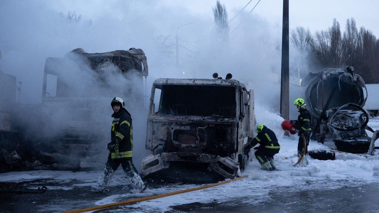 Emergency personnel survey a damaged site in Kyiv after the attack, working through the night to contain fires and restore order amid power outages