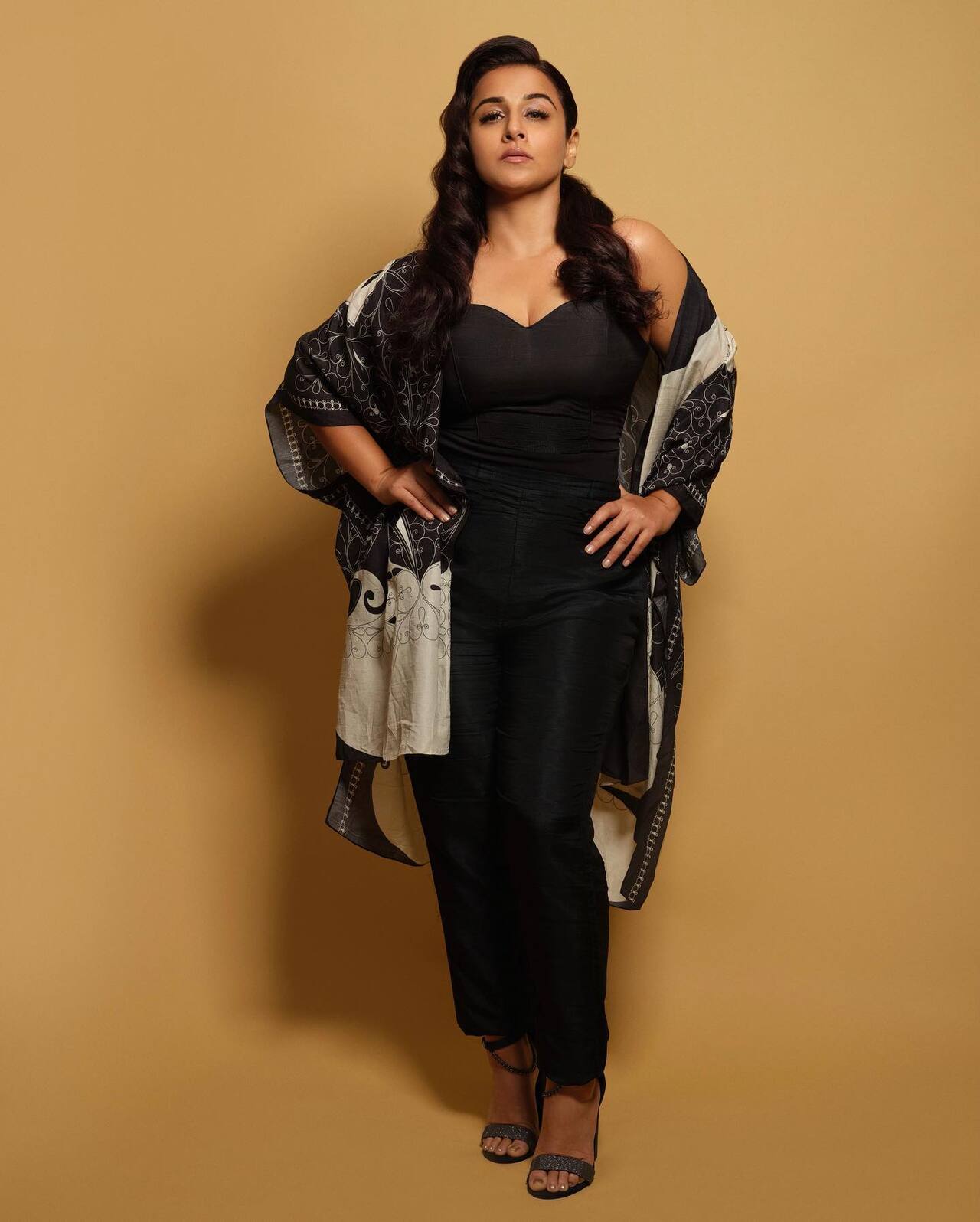 <p>Vidya Balan channels effortless glam in a sleek black strapless ensemble, elevated with a printed drape that adds drama.</p>