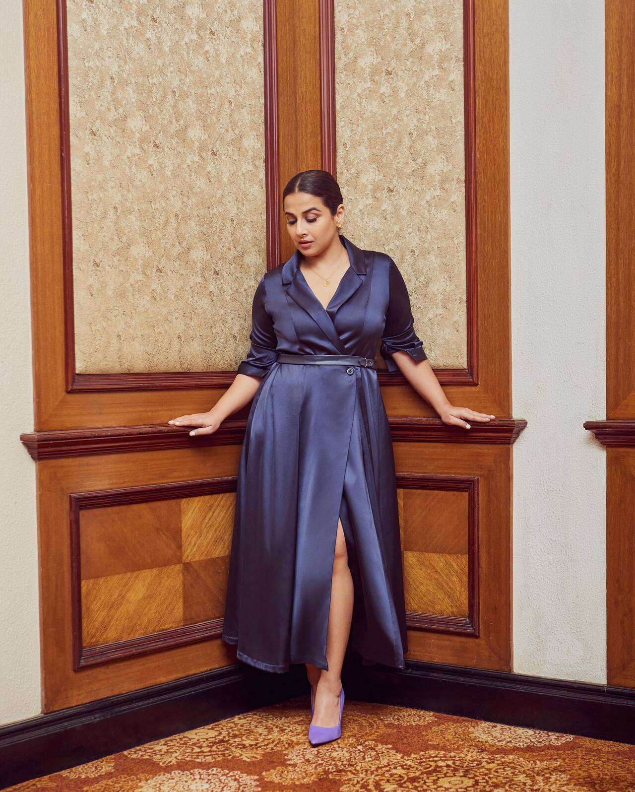 <p>Vidya Balan exudes glamour in a satin blue dress with a thigh-high slit, perfectly blending sophistication with a touch of drama.</p>
