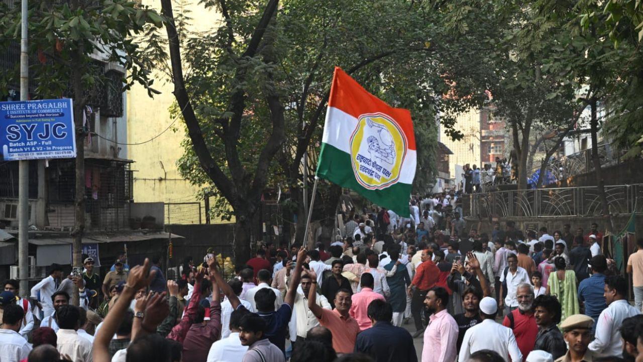 Ajit Ravrane poses with party workers and supporters following his victory in ward No. 43 as counting continues for the BMC election 2025–26 in Malad (East)