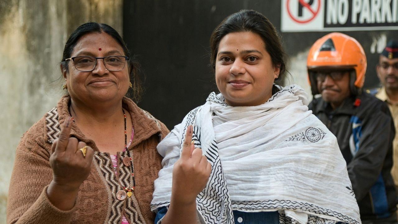 Enthusiastic voters show the ink on their fingers after casting votes in the local body polls