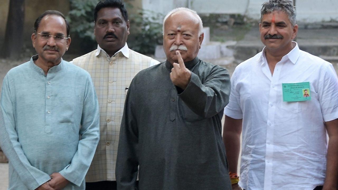 Rashtriya Swayamsevak Sangh (RSS) chief Mohan Bhagwat shows his ink-marked finger after casting a vote at a polling station during the Nagpur Municipal Corporation (NMC)
