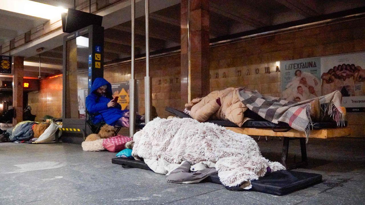 Civilians rush to take shelter at a Kyiv metro station as air raid sirens blare, moments after Russian drone strikes hit the Ukrainian capital
