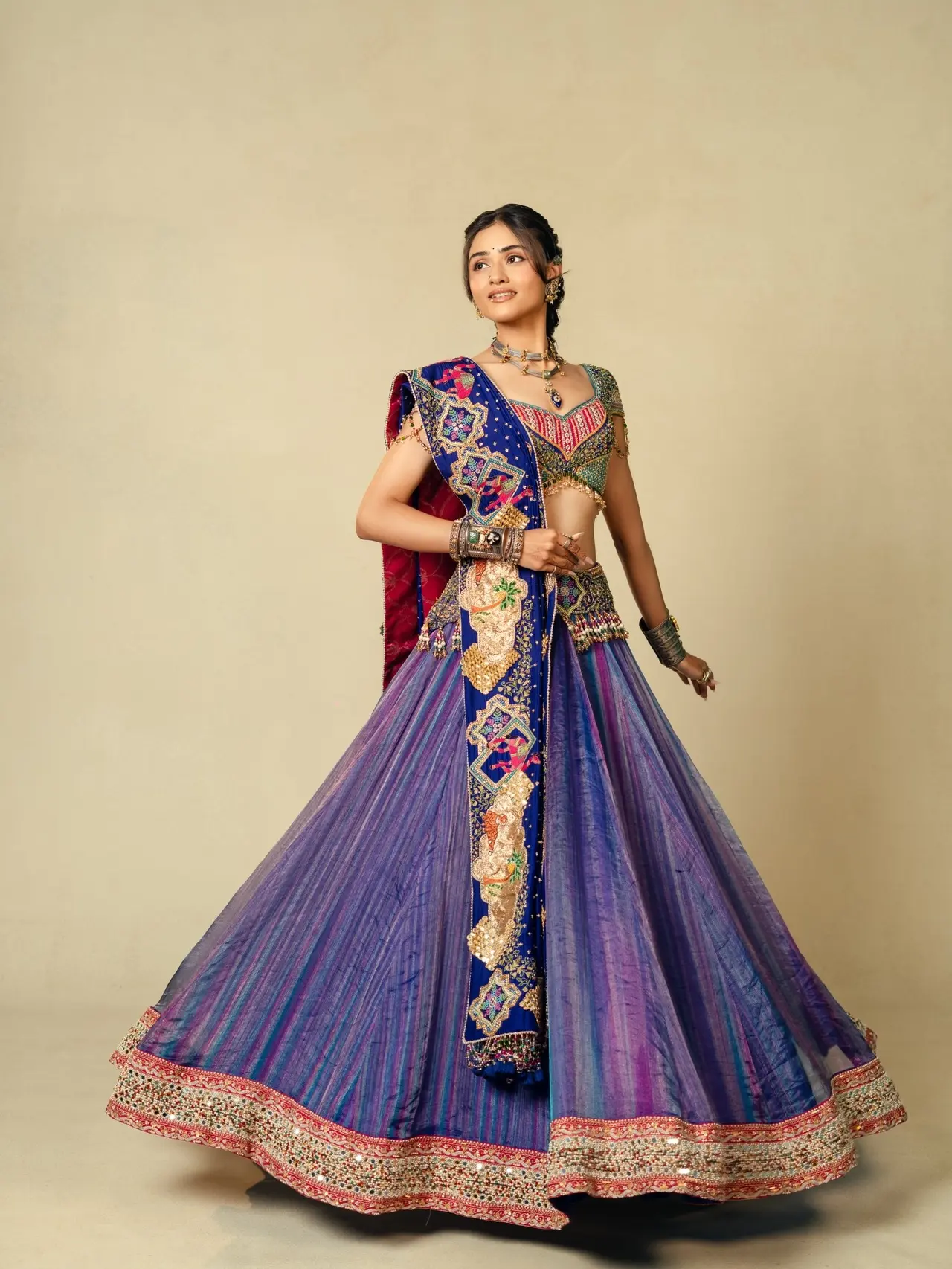 Janki Bodiwala looks resplendent in a richly embroidered lehenga featuring vibrant hues and intricate traditional motifs. Paired with statement jewellery and a beautifully draped dupatta, the ensemble perfectly captures regal elegance.