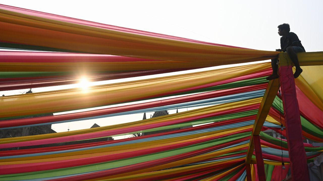 <p>Crew members putting up colorful curtains to brighten the festival venue </p> <p>Crew members putting up colorful curtains to brighten the festival venue </p>