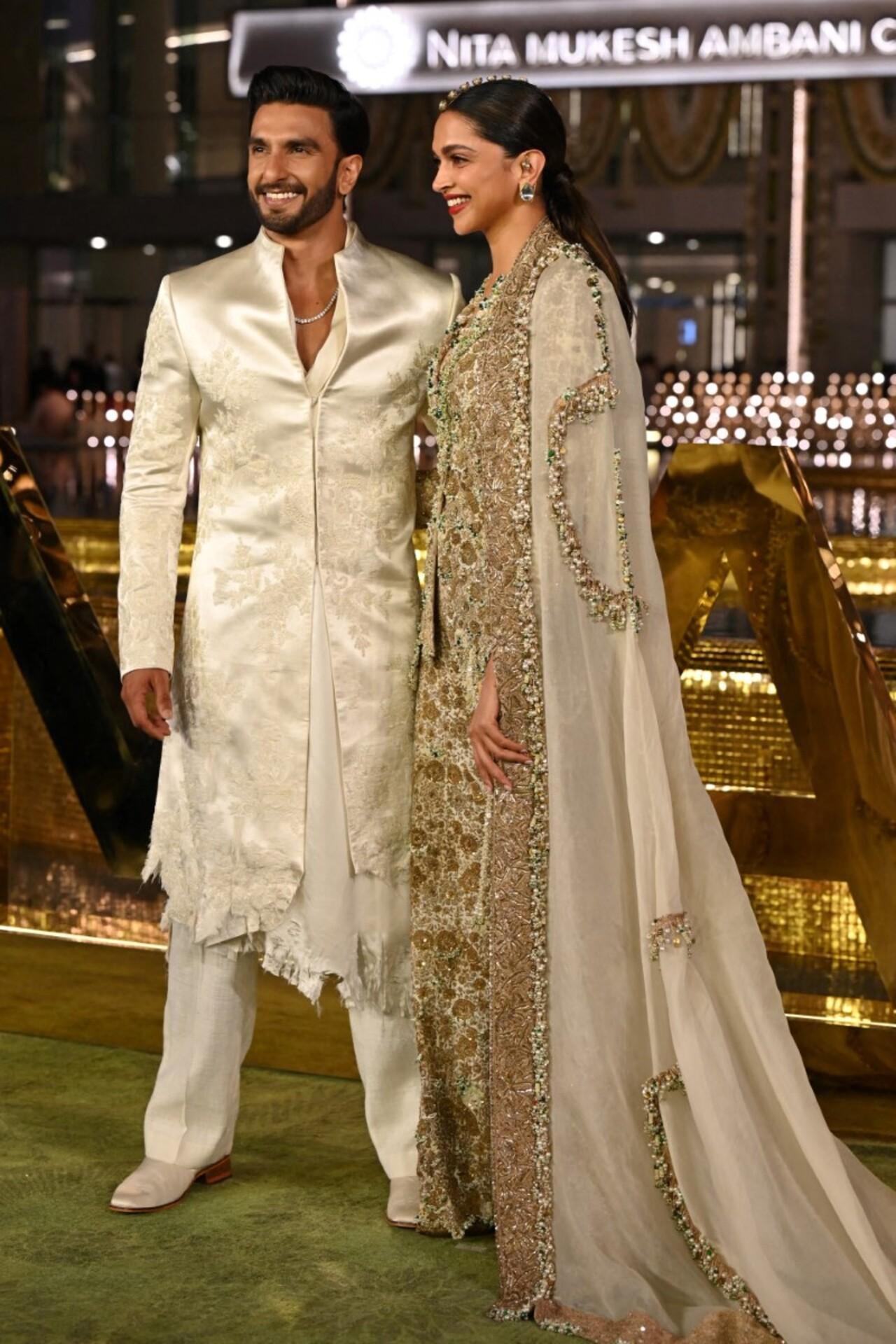 Deepika Padukone looked regal and radiant in a heavily embellished ivory-and-gold ethnic ensemble, featuring intricate embroidery and shimmering detailing. She paired the ornate outfit with a sheer dupatta.
