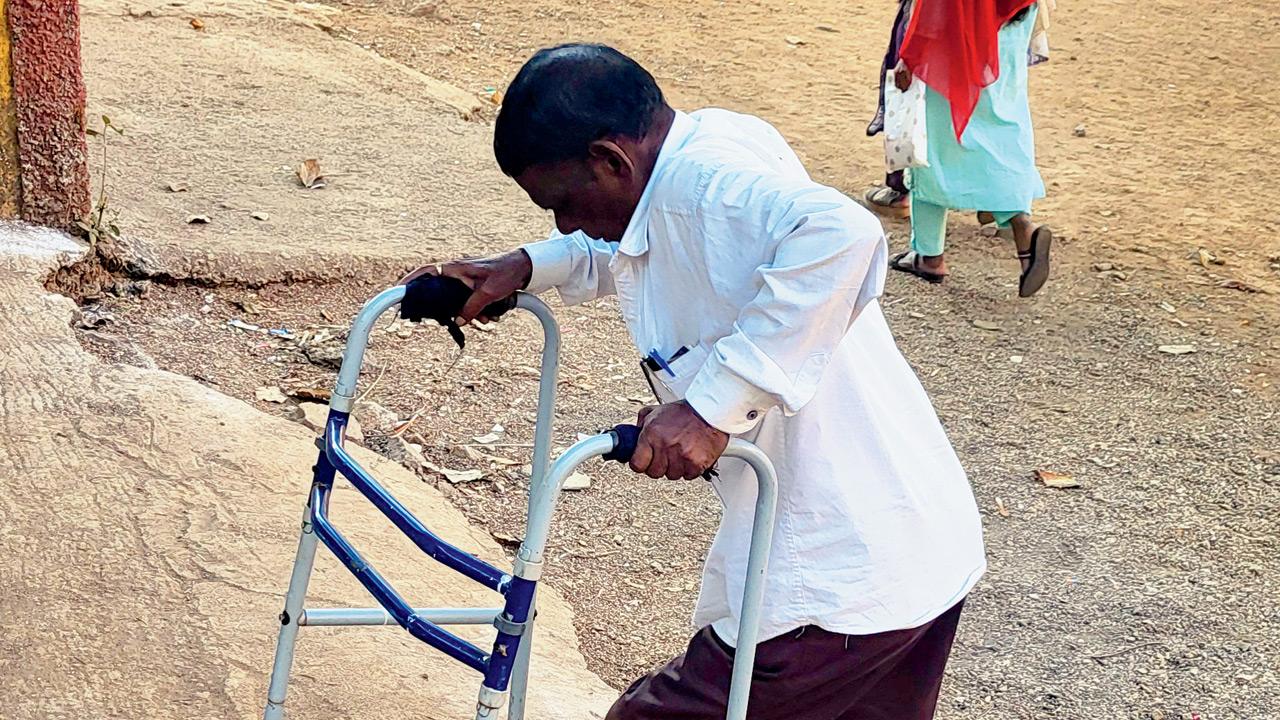 A disabled voter struggles to navigate the uneven ground