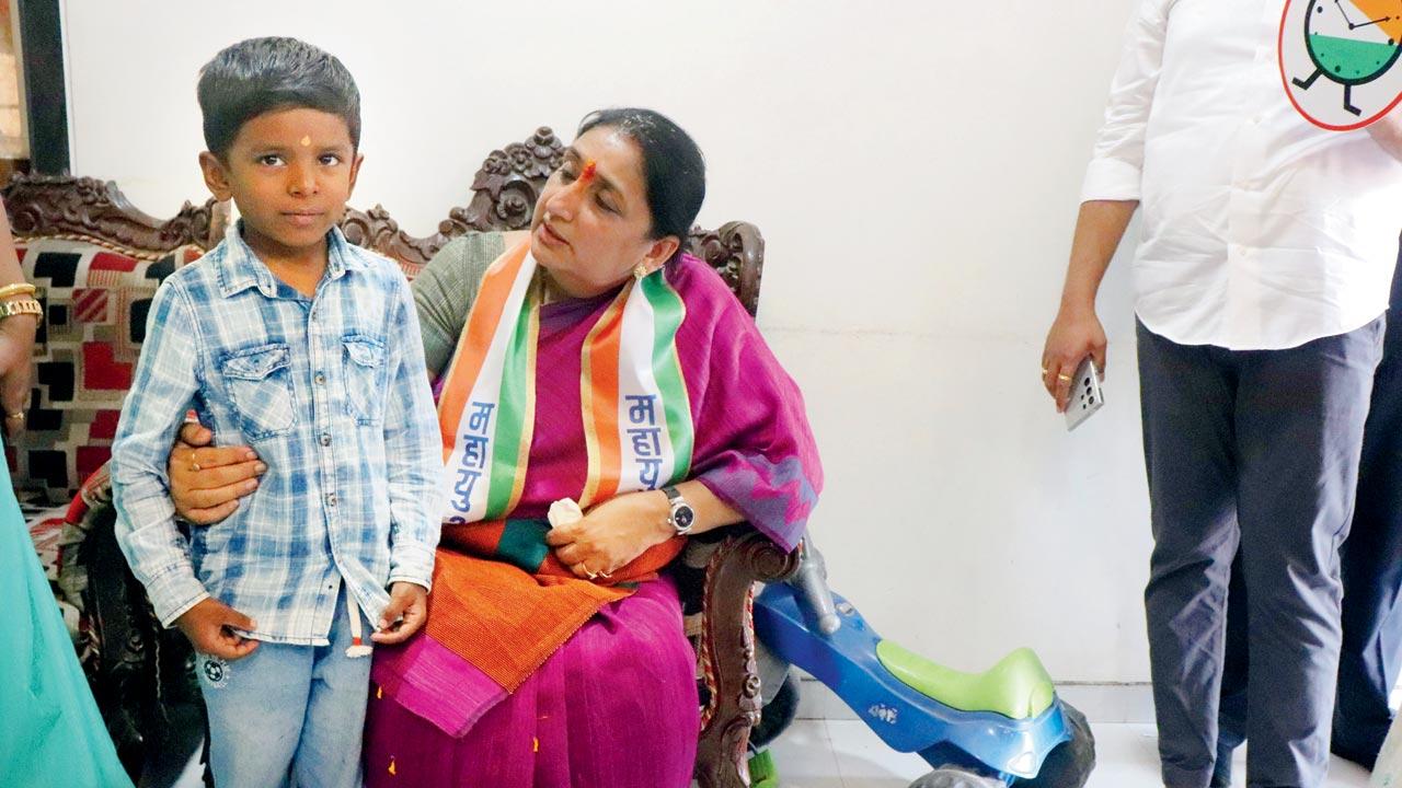 NCP leader Sunetra Pawar interacts with a child while canvassing for votes in Pune in the run-up to state election in 2024. File pic