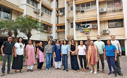 Residents of Ruia Park Apartments pose in front of their building on Military Road in Juhu. File pic/Satej Shinde