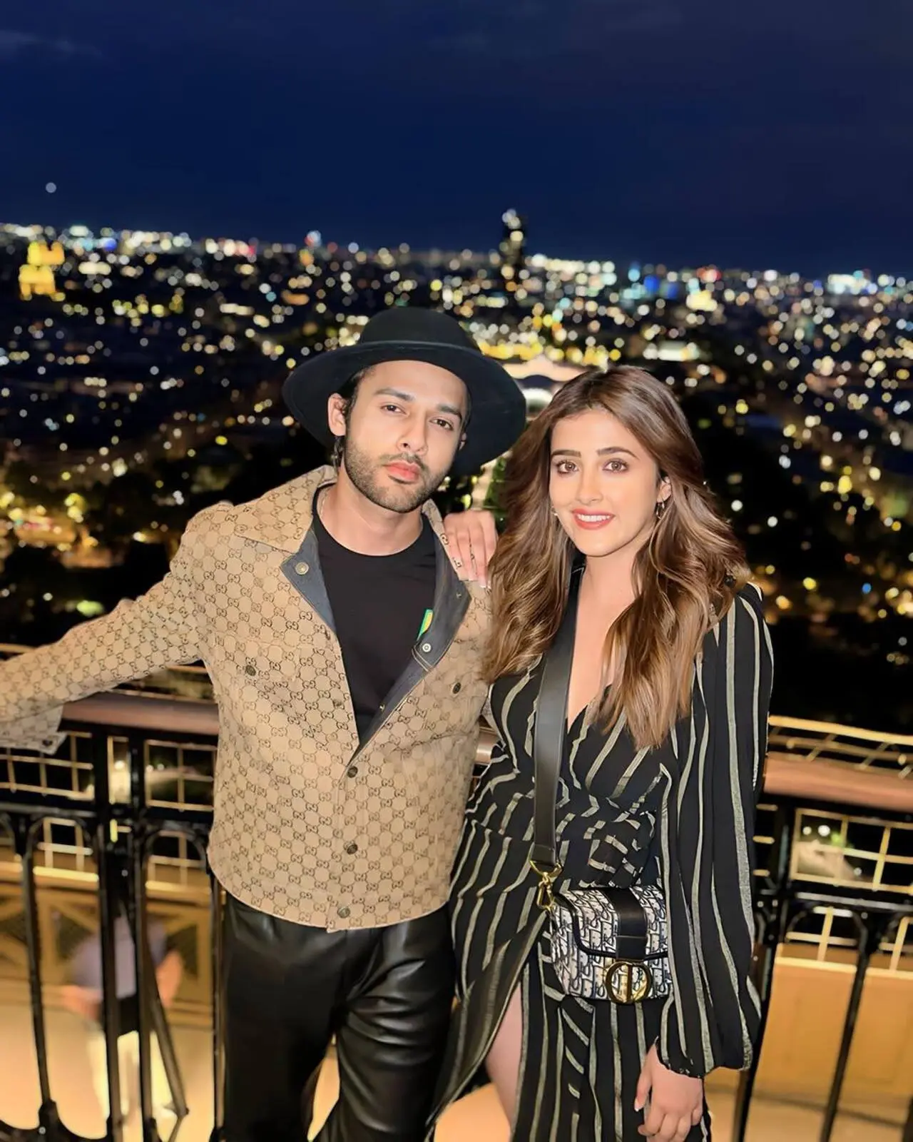 Nupur Sanon and Stebin Ben look absolutely adorable as they pose against a glittering cityscape at night. Their effortless smiles and chemistry make this picture a perfect blend of romance and style.