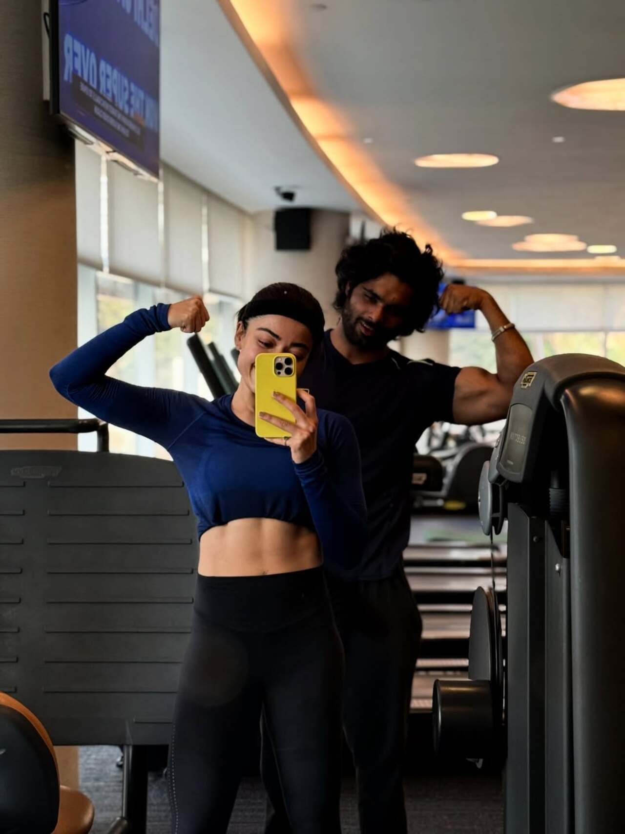 Rashmika Mandanna keeps it real and sporty as she poses with her trainer at the gym, showcasing her dedication to fitness.