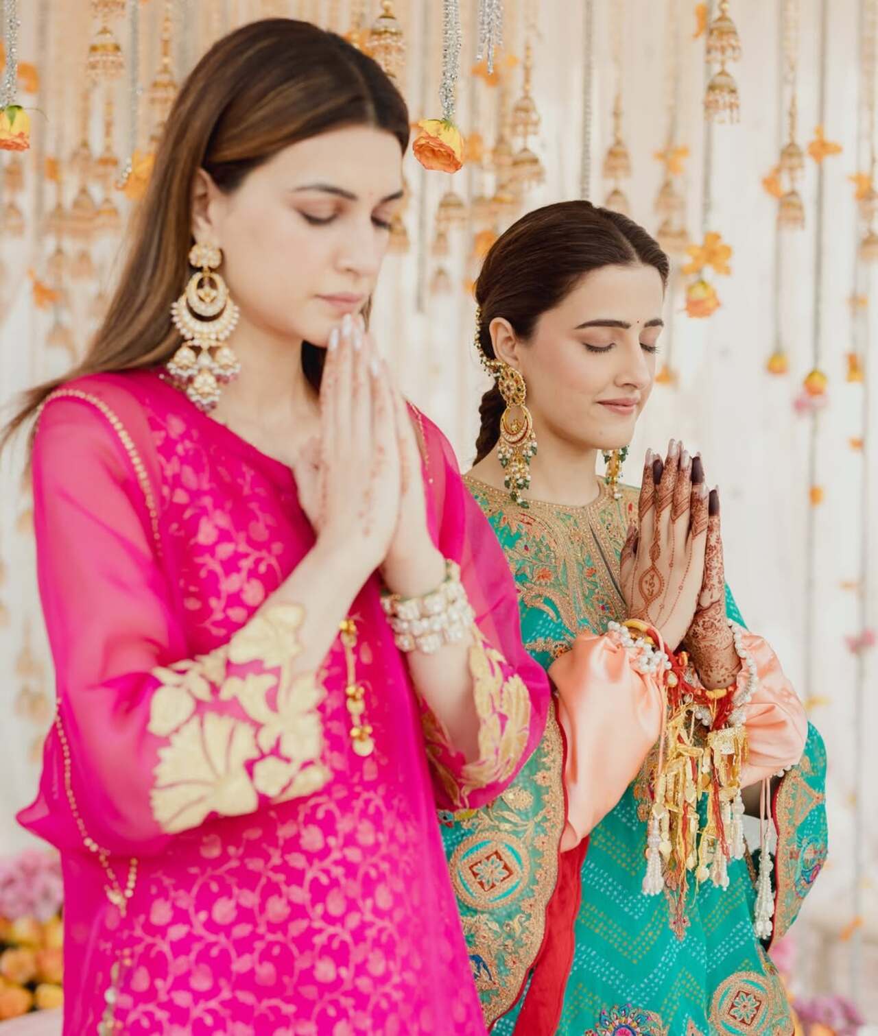 <p>The sister duo is seen praying together amid the wedding rituals, sharing a quiet and heartfelt moment.</p>
