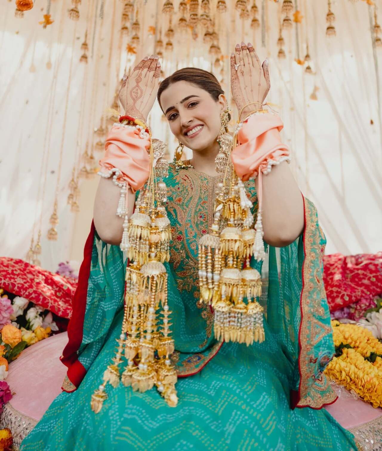 <p>Nupur Sanon is seen happily flaunting her choora, smiling brightly as she lifts her hands to show off the beautiful bridal bangles.</p>