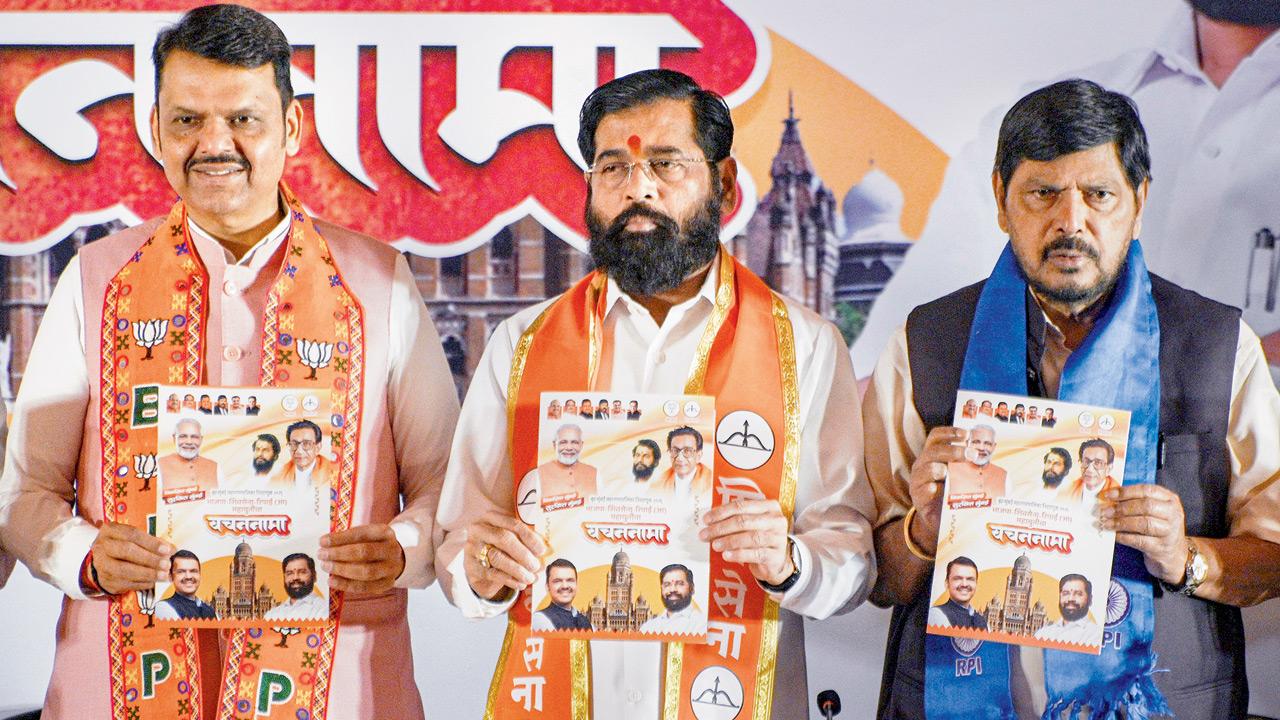 (From left) Maharashtra Chief Minister Devendra Fadnavis, Deputy Chief Minister Eknath Shinde, and Republican Party of India (A) MP Ramdas Athawale during the release of Mahayuti’s manifesto for the Brihanmumbai Municipal Corporation election in Bandra East on Sunday. Pic/PTI