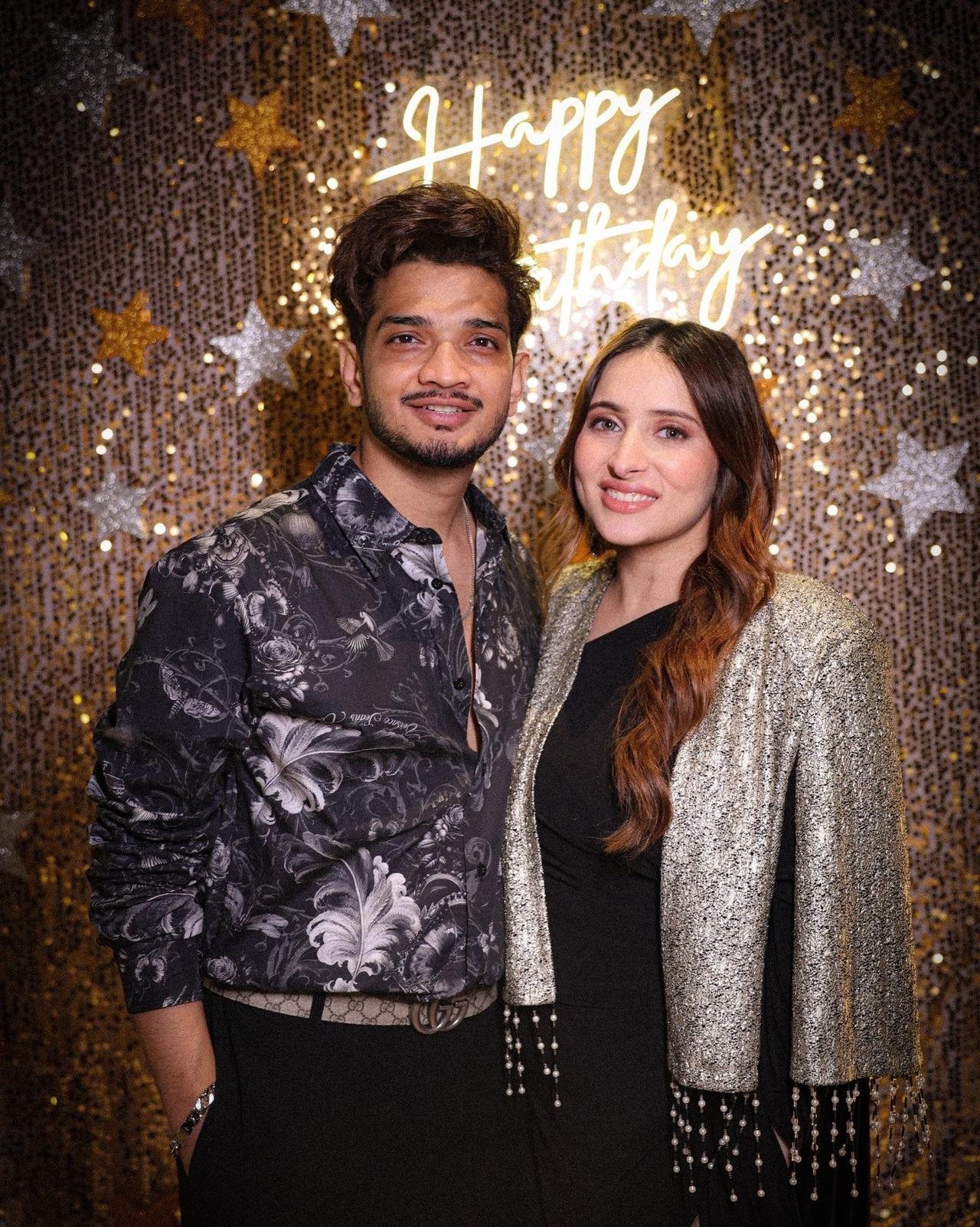 Munawar Faruqui posed with wife, Mehzabeen Coatwala, at his birthday celebrations. She wore a black outfit with a silver jacket.