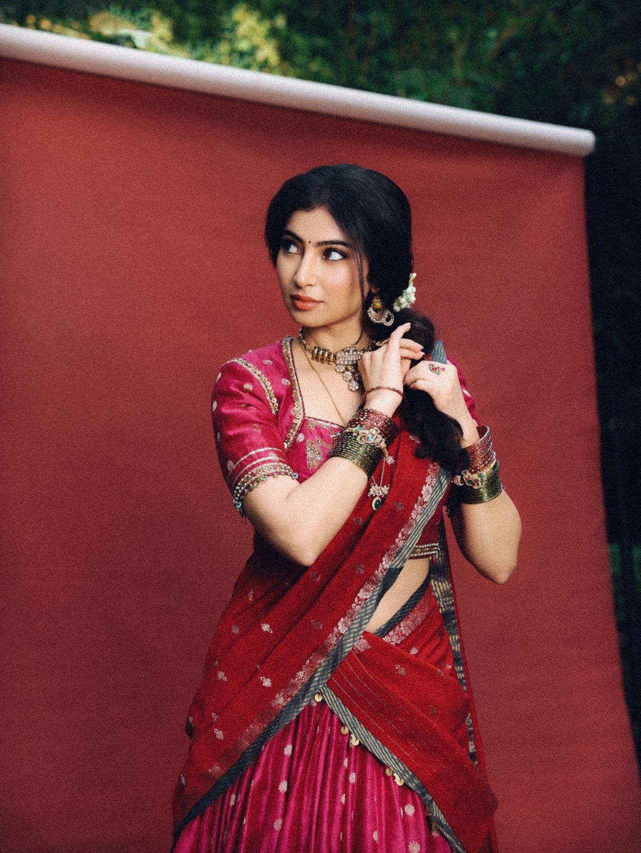 Her hair was neatly done in a lose messy braid, adorned with a white gajra.