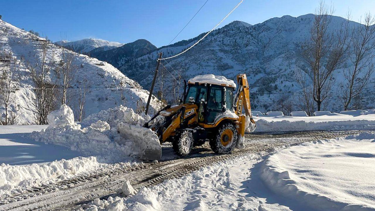 A backhoe loader deployed to clear a snow-blocked road following heavy snowfall in Jammu and Kashmir’s Rajouri district. PIC/ PTI