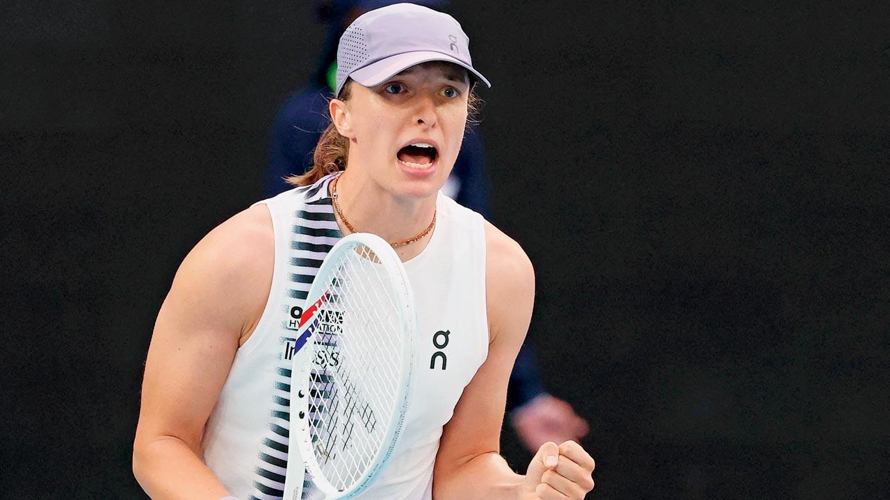 Iga Swiatek celebrates winning the first set against Yuan Yue on Monday