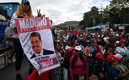 A demonstrator holds an allusive poster during a march in Caracas. Pic/AFP