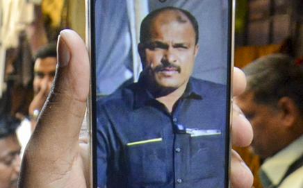 A man shows a photograph of Vidip Jadhav on his phone. Pic/PTI