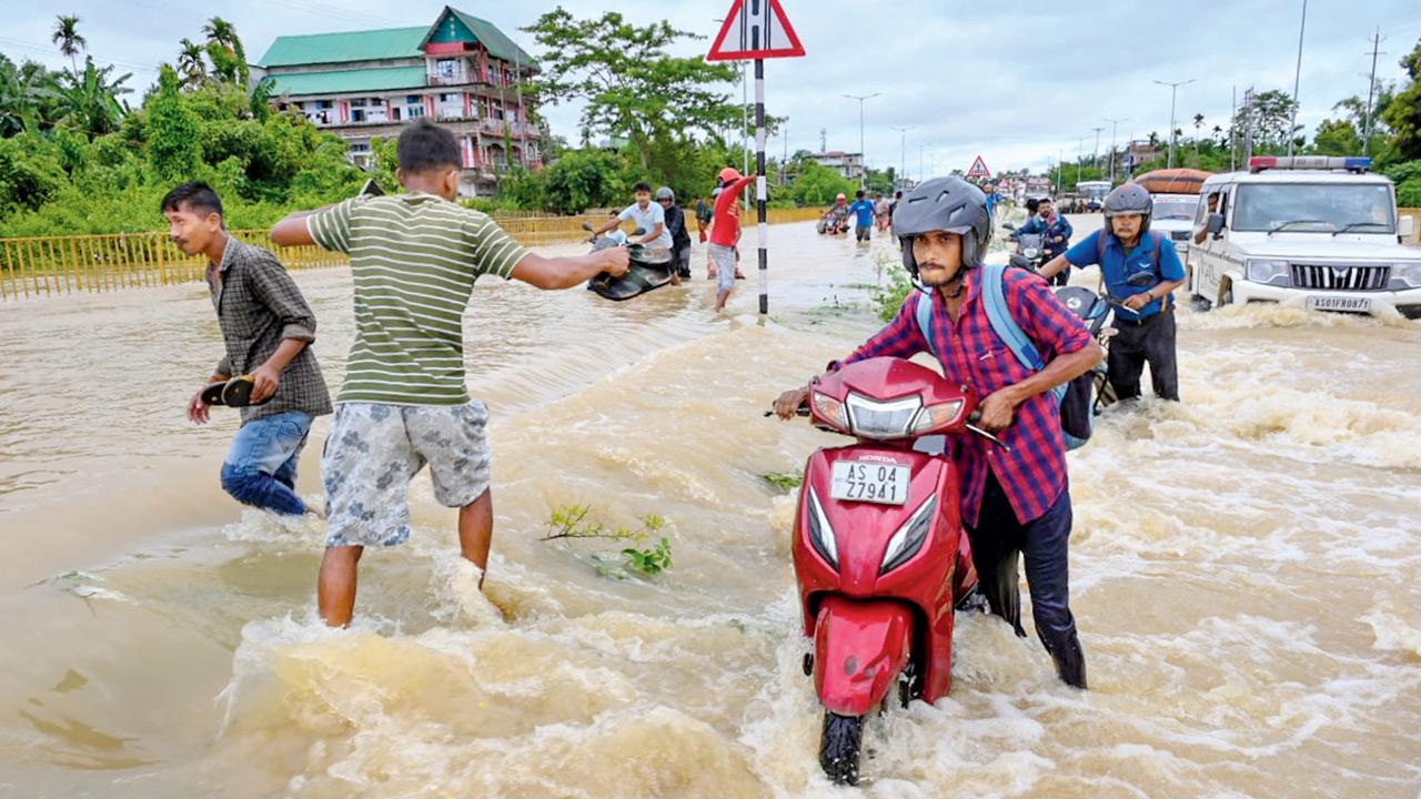 Army steps in as Assam floods worsen, 1.7 lakh affected People wade through floodwaters in Jorhat district on Monday. PIC/PTI