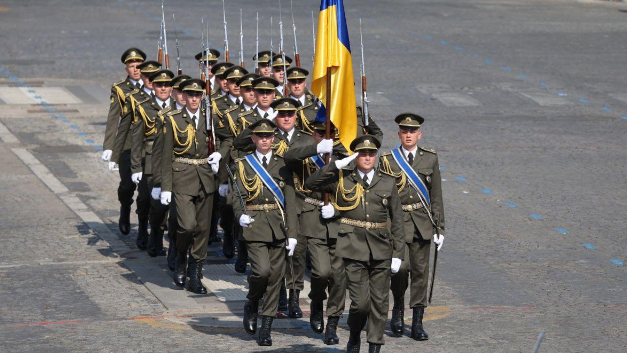 Ukrainian troops marched along the cobblestoned avenue, and Ukrainian co-pilots trained in France flew two Mirage 2000B fighter jets alongside French air force pilots.