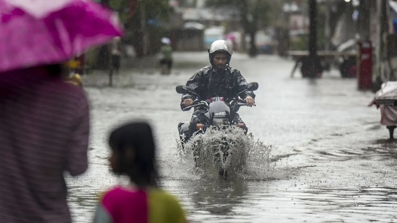 Maharashtra weather update: IMD issues red alert for Mumbai, Thane, Raigad Commuters wade through a waterlogged street in Mumbai on Monday. PIC/PTI