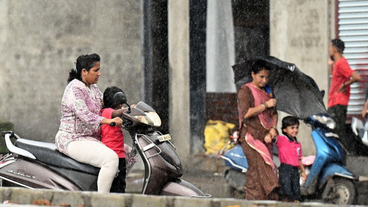 IN PHOTOS | Umbrellas, puddles and traffic mark another monsoon day in Mumbai Commuters navigate rain as monsoon showers continue at Thakur Village, Kandivali East, in Mumbai on Thursday. PIC/SATEJ SHINDE