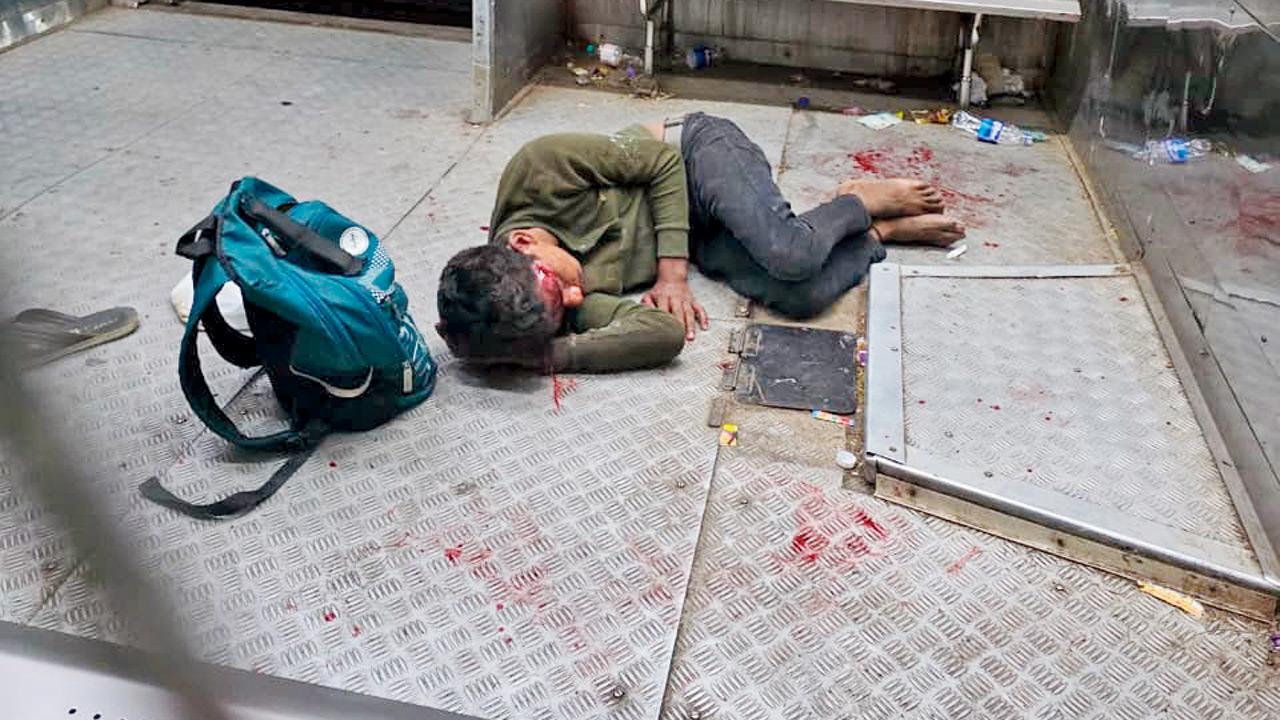 Two injured after seat dispute turns violent on Mumbai local train Raju lies injured inside the luggage compartment. Pic/By Special Arrangement