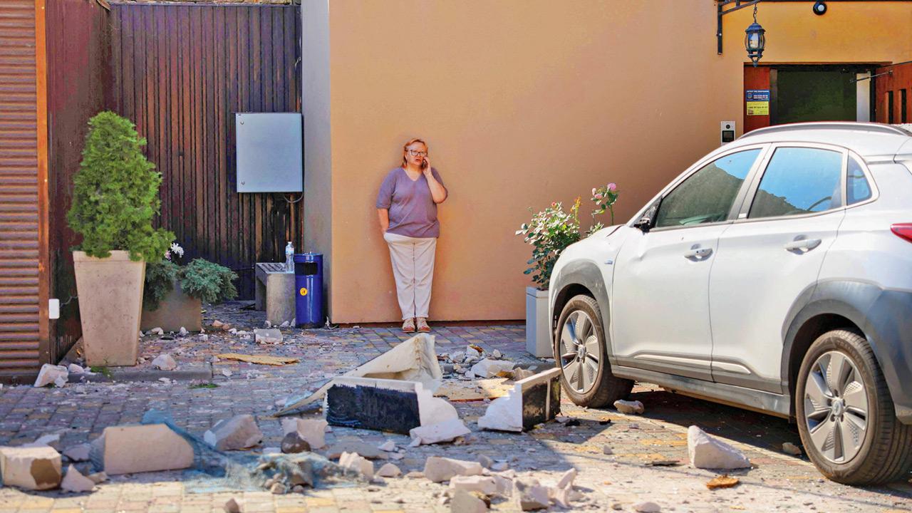 Ukraine claims strike on 20 Russian vessels in Black Sea A woman stands near debris following a Russian strike in Odesa. PIC/AFP