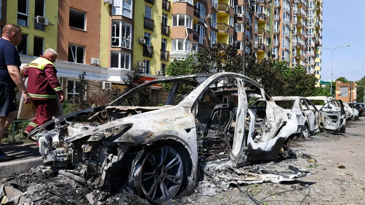 Death toll from Russia's overnight Ukraine strikes rises to 6 People walk past damaged cars parked in a street following missile strikes in Kyiv on Sunday, July 19. PIC/ AFP